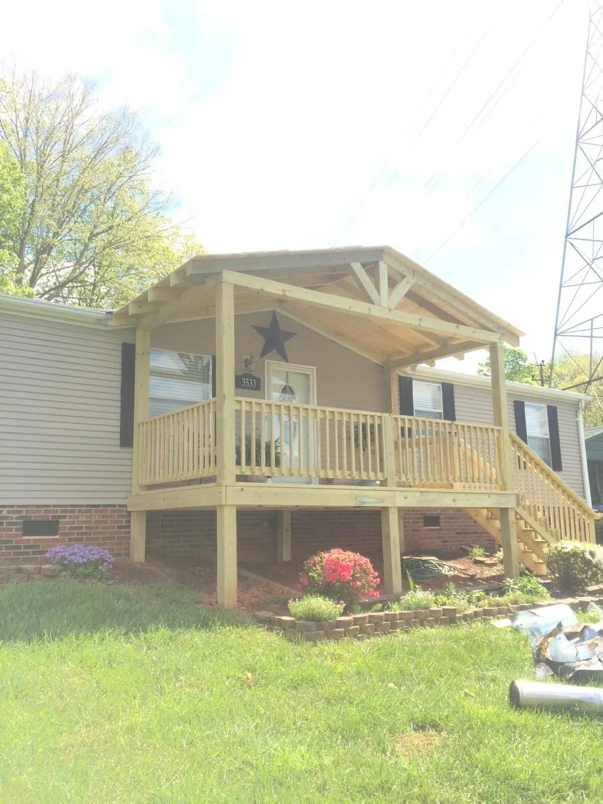 New gabled porch roof and deck railing added to a ranch home in Otisville